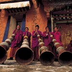 Music lesson for Labrang's monks using the traditional 13-foot horns. Tibet.